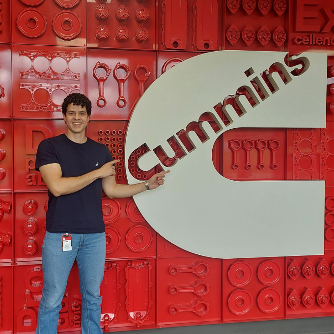 Student pointing to Cummins sign